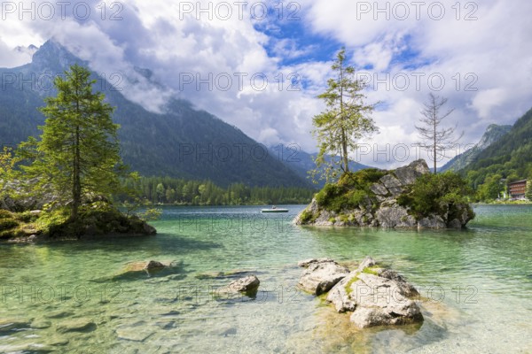 Hintersee near Ramsau with clear green water, surrounded by forests and mountains under a cloudy sky, pedal boat, Berchtesgaden National Park, Berchtesgadener Land, Upper Bavaria, Bavaria, Germany, Europe