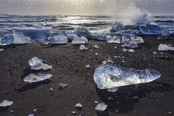 Ice floes on the beach, waves, sea, clouds, sunlight, winter, Diamond Beach, Breidamerkursandur, Jökulsarlon, Iceland, Europe