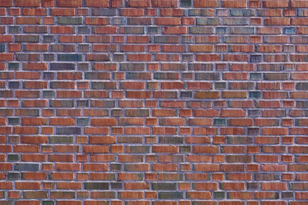 Detailed view of a brick wall with red and brown bricks forming a regular pattern, Bergen, Vestland, Norway, Europe