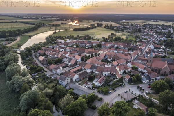 Aerial view of village Lenzen and river Loecknitz (Löcknitz) at sunset, Brandenburg, Germany, Europe