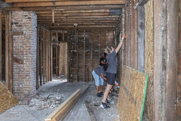 Detroit, Michigan, NW Goldberg Cares, a nonprofit community development corporation, rebuilds a neglected old house in the NW Goldberg neighborhood. Volunteers from Rocket Mortgage helped with the work