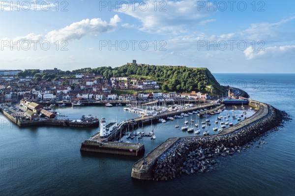 Scarborough Lighthouse and Harbour from a drone, Vincent Pier, Scarborough, North Yorkshire, England, United Kingdom, Europe