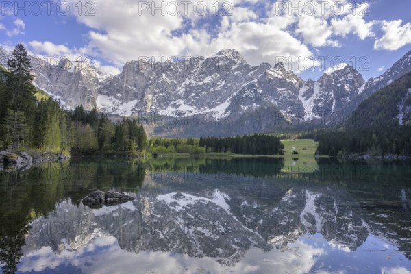 The Mangart mountain range reflected in Lake Fusine, Tarvisio, province of Udine, Italy, Europe
