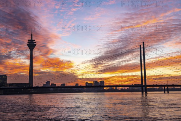 Winter sunset on the Rhine near Düsseldorf, Rhine Tower, cargo ship, Rhine knee bridge, North Rhine-Westphalia, Germany, Europe
