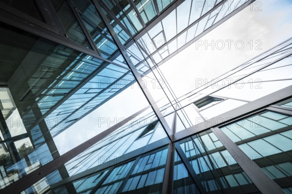 Mirrored modern building façades rise into the sky, reflecting blue and white, University of Stuttgart, Germany, Europe
