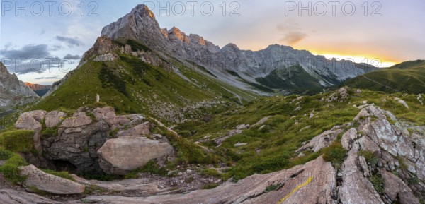 Panorama, alpenglow at the Biegenköpfen and Wolayerkopf, mountain landscape with green meadows and rocky mountain peaks at sunset, Carnic Alps, Carnic High Trail, Carinthia, Austria, Europe
