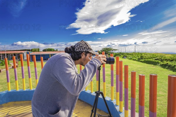 Photographer photographing a beautiful landscape. Person photographing landscape with a digital camera in a park