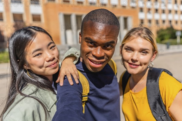 Frontal personal perspective and close-up photo of an african man taking selfie with university colleagues at campus