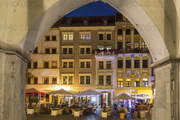 View through the arches of the arcades of the hall houses to the row of street cafés at night, Untermarkt Görlitz, Saxony, Germany, Europe
