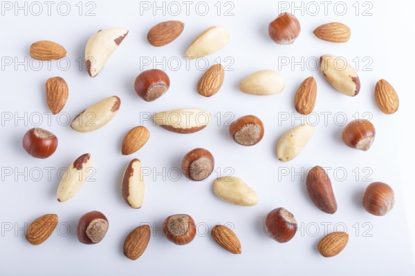 Pattern made from different kinds of nuts. isolated on white. hazelnut, brazil nut, almond, pumpkin seeds. top view