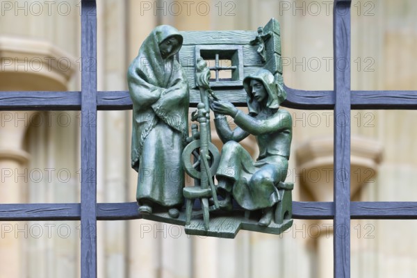 Prague castle, Gothic Metropolitan Cathedral of Saints Vitus, Wenceslas and Adalbert, Decorative figure of daily life scene on a fence, Prague, Czech Republic, Europe