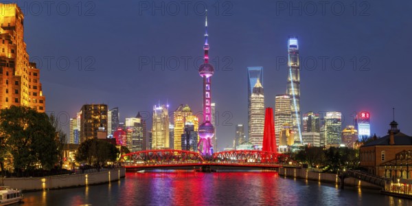 Shanghai skyline at the Bund with Oriental Pearl Tower city centre downtown panorama at night in Shanghai, China, Asia