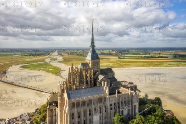 Aerial view of the imposing abbey in an extensive sand and water landscape, Le Mont-Saint-Michel