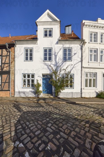 Historic house, dormer, façade with windows and door, street An der Obertrave made of cobblestones, Old Town, Hanseatic City of Lübeck, independent city, Schleswig-Holstein, Germany, Europe