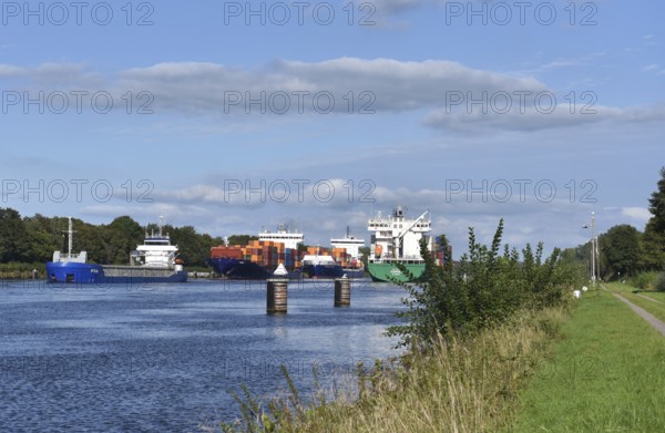Cargo ship and container ship meet in the Kiel Canal, Kiel Canal in a ship siding, Schleswig-Holstein, Germany, Europe