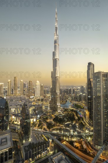 An impressive view of the Burj Khalifa at dusk, surrounded by the twinkling lights of the modern cityscape, Dubai, United Arab Emirates, Asia