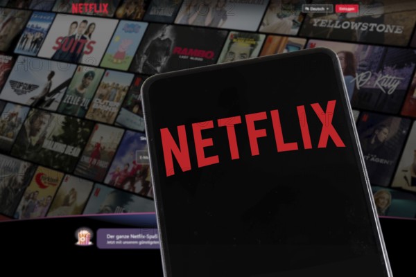 Netflix logo website on a mobile phone and computer screen in Stuttgart, Germany, Europe