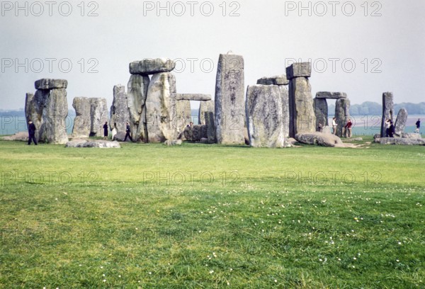 People exploring the standing stones at the Neolithic site of Stonehenge, Wiltshire, England, UK 1961