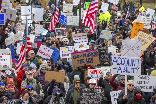 Lansing, Michigan USA - 5 February 2025 - People rally at the Michigan state capitol to oppose President Trump, Elon Musk, and Project 2025. Similar rallies were planned across the country, many of them at state capitols