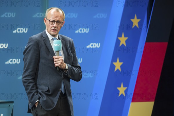 Election event of the CDU party for the Bundestag elections with top candidate Friedrich Merz. Portrait in front of the German flag and the flag of the European Union. Singen am Hohentwiehl. Baden-Württemberg, Germany, Europe