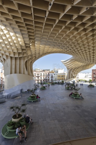 Modern architecture of the Metropol Parasol with people enjoying the shade in the square, Seville