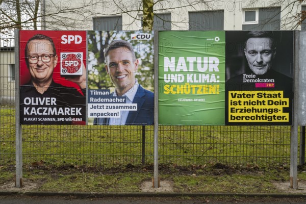 Board with election posters, SPD, CDU, Bündnis90 Die Grünen, FDP, Bundestag election 2025, Kamen, North Rhine-Westphalia, Germany, Europe