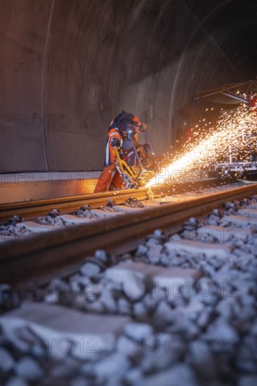 Night-time welding in the tunnel with flying sparks and protected workers, rail welding, track construction Hermann Hessebahn, Calw, Black Forest, Germany, Europe