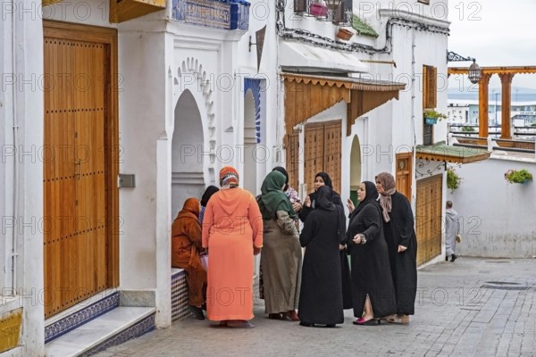 Moroccan Muslim women in traditional Islamic dress wearing hijab in medina of the city Tangier, Tanger, Morocco, Africa