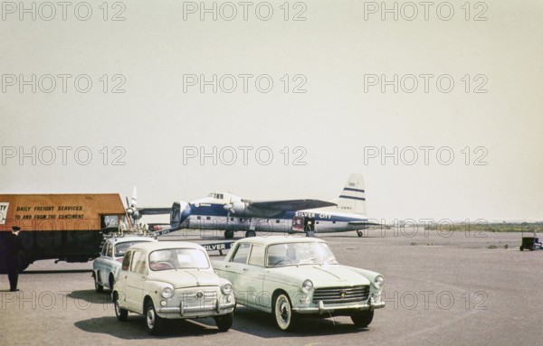 Bristol Superfreighter aircraft G AMWE, Silver City Airways airline air ferry, Ferryfield airport, Lydd airfield, Kent England, UK 1960 brand new Peugeot 404 saloon and Fiat 600 cars