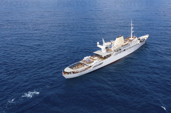 Aerial view 99 metre long motor yacht Christina O, former frigate built in 1942 by Canadian Vickers, converted for Aristotle Onassis, on board were Maria Callas, Winston Churchill, John F. and Jackie Kennedy, Tito, Grace Kelly, Prince Rainier III of Monaco, Frank Sinatra, Richard Burton, Elizabeth Taylor, Greta Garbo, John Wayne, Marilyn Monroe, John D. Rockefeller, Paul McCartney, Prince Andrew, Sarah Ferguson, Madonna, Johnny Depp. Here the yacht is cruising off Menton on the French Riviera, Mediterranean Sea