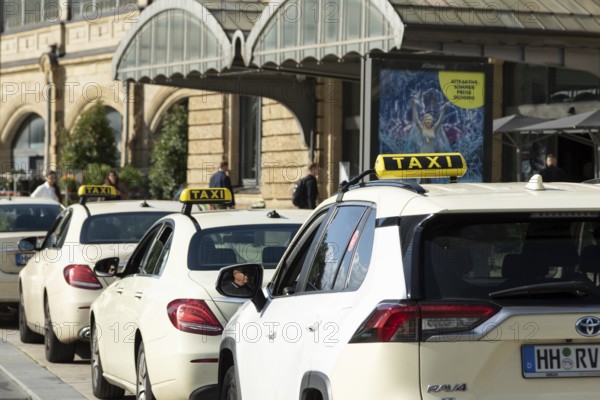 Taxis parked at a taxi rank in front of Dammtor train station in Hamburg, Germany, Europe