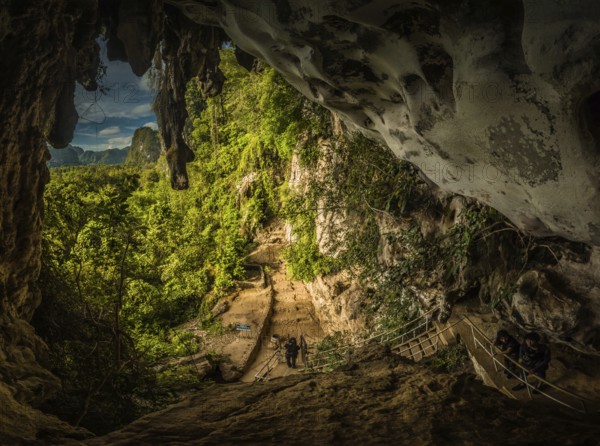 Photo of greenery and cave famous for paintings of wild animals and hand markings with petroglyphs near Maros in southwestern Sulawesi in Indonesia