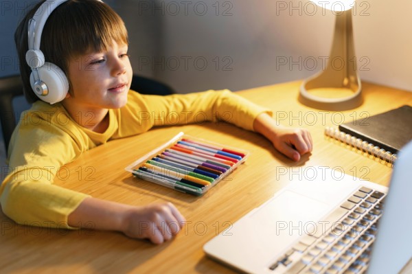 High view child taking virtual courses