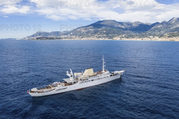 Aerial view 99 metre long motor yacht Christina O, former frigate built in 1942 by Canadian Vickers, converted for Aristotle Onassis, on board were Maria Callas, Winston Churchill, John F. and Jackie Kennedy, Tito, Grace Kelly, Prince Rainier III of Monaco, Frank Sinatra, Richard Burton, Elizabeth Taylor, Greta Garbo, John Wayne, Marilyn Monroe, John D. Rockefeller, Paul McCartney, Prince Andrew, Sarah Ferguson, Madonna, Johnny Depp. Here the yacht is cruising off Menton on the French Riviera, Mediterranean Sea