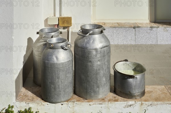 Some milk cans waiting to be taken away