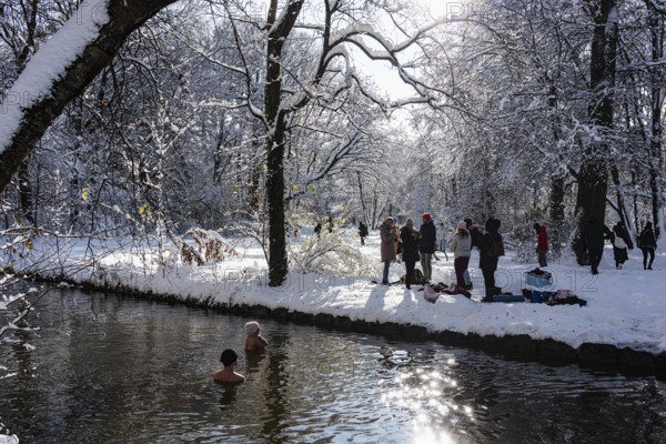 Ice bathing in the stream, people, stream and trees, winter with snow in the southern part of the English Garden, Munich, Bavaria, Germany, Europe