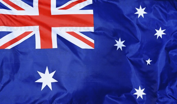 Close-up of the national flag of Australia, fluttering in the wind with folds, wave pattern