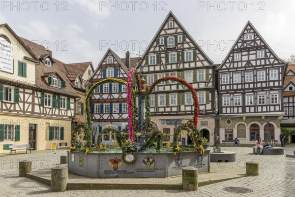 Schorndorf Easter fountain (market fountain) on the upper market square and in the background large and beautiful half-timbered houses, Schorndorf, Baden-Württemberg, Germany, Europe