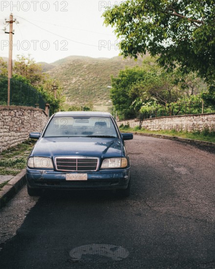 Old Mercedes car parked in village between Albanian mountaing