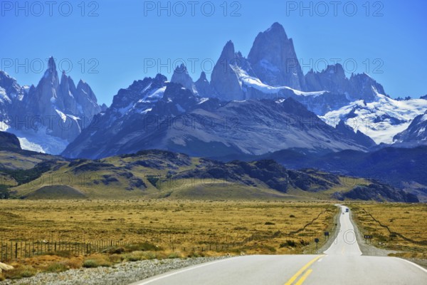 Famous rock Fitz Roy peaks in the Andes. Magnificent panorama of snow-capped mountains in Patagonia. To mountains leads the asphalt road