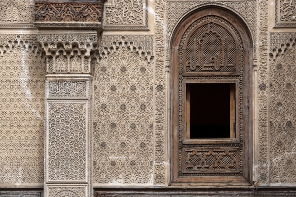 Fes, Morocco, April 04, 2023, Rich decorated facade in the courtyard of the Medersa Attarine in Fes, Morocco, Africa