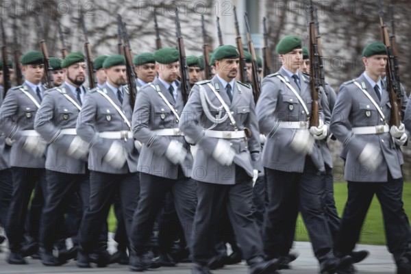 Army soldiers of the guard battalion march as part of an honour formation at the Chancellery in Berlin, 27.03.2024