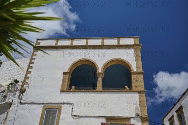 White building with arches and columns under a bright blue sky, Mediterranean, Chora, main town Patmos, Patmos, Old Town, Dodecanese, Greek Islands, Greece, Europe