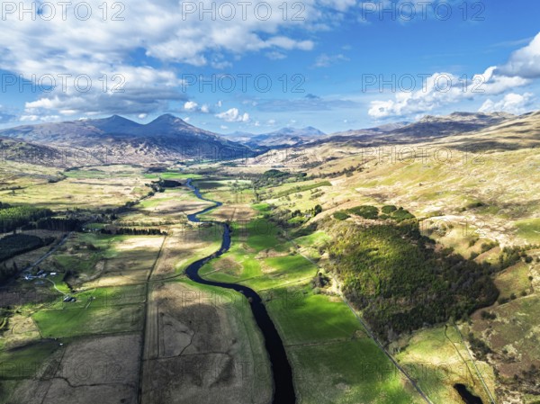 Farms and Mountains over River Dochart and Road A85 from a drone, Perthshire, Scotland, UK