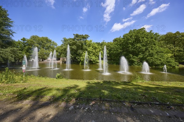 Fountain in a pond in Bochum municipal park, Ruhr district, independent city, North Rhine-Westphalia, Germany, Europe