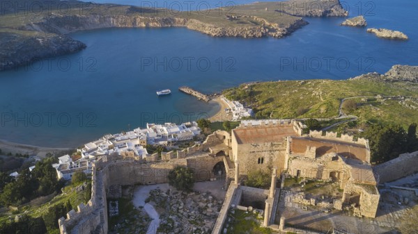 Drone shot, Lindos, late afternoon light, drone view of an old windmill on a rocky shore in the golden light of dusk, Archaeological site, Lindos, Rhodes, Dodecanese, Greek Islands, Greece, Europe
