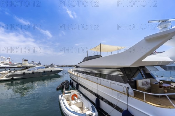 France, French Riviera, Monte Carlo marina with luxury yachts and cars in Monaco bay, Europe