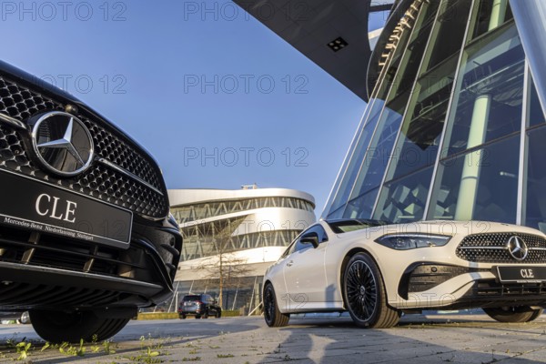 New Mercedes cars at the Stuttgart branch, with the Mercedes Museum behind it. Stuttgart, Baden-Württemberg, Germany, Europe