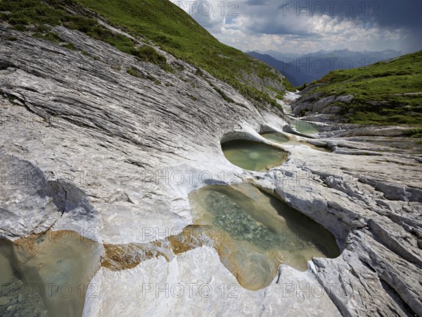 Glacier mill with glacier pots on the Trinser Alp Mora, Trin, Canton Graubünden, Switzerland, Europe