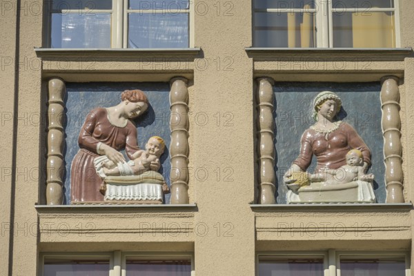 Mothers looking after their babies, relief on an old building, former woman's and children's clinic, today St. Marien residential park, Mariendorfer Weg, Neukölln, Berlin, Germany, Europe